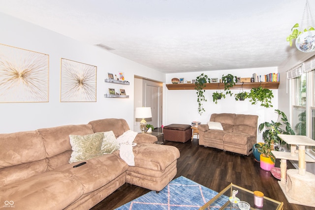 living room featuring visible vents and wood finished floors