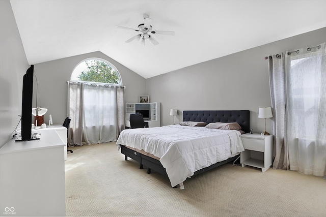 bedroom with lofted ceiling, a ceiling fan, and light carpet