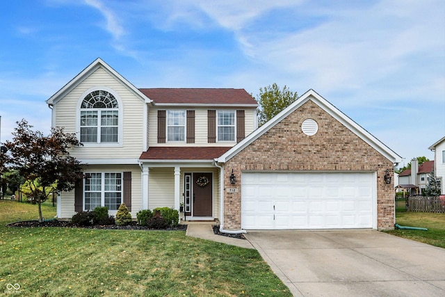 traditional-style home featuring a garage, concrete driveway, and a front yard