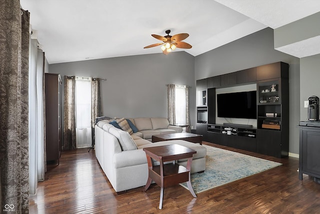 living room featuring dark wood finished floors, vaulted ceiling, baseboards, and ceiling fan