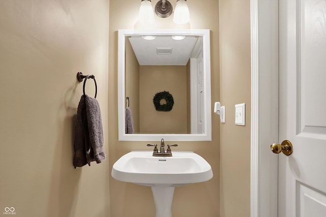 bathroom featuring a sink and visible vents