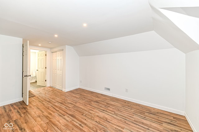 bonus room with visible vents, baseboards, and light wood-style floors