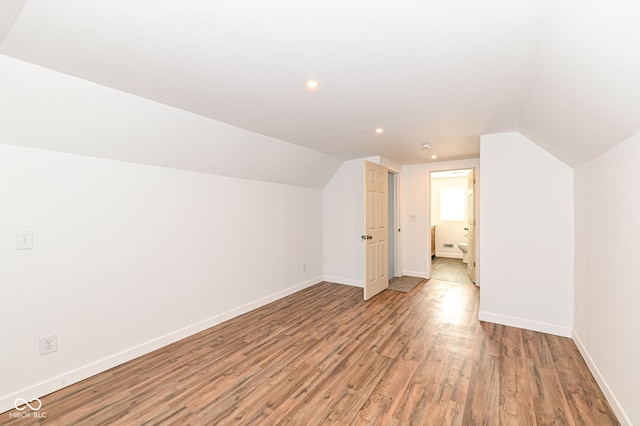 bonus room with light wood finished floors, recessed lighting, lofted ceiling, and baseboards