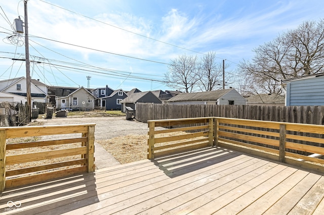 wooden terrace featuring a residential view and fence