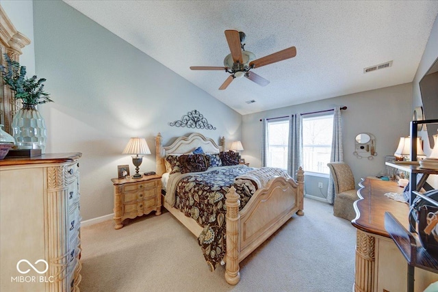 bedroom featuring a textured ceiling, vaulted ceiling, visible vents, and light carpet