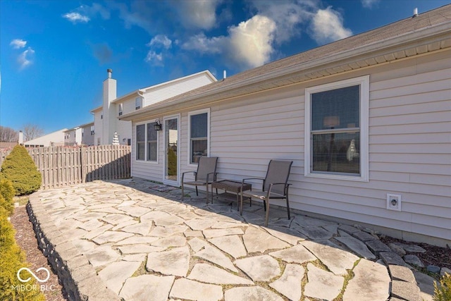 view of patio featuring fence