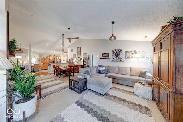 living room featuring a textured ceiling, lofted ceiling, visible vents, and light carpet