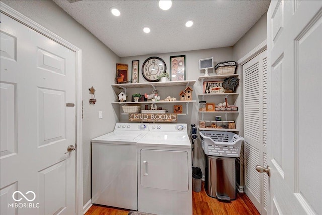 laundry room featuring light wood finished floors, laundry area, recessed lighting, separate washer and dryer, and a textured ceiling