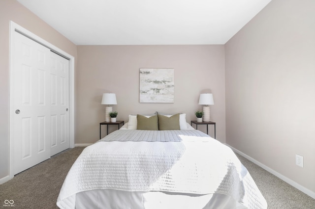 carpeted bedroom with a closet and baseboards