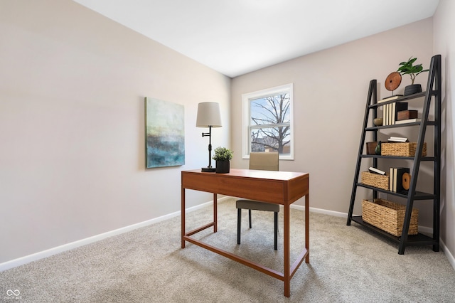 office area featuring baseboards and light colored carpet