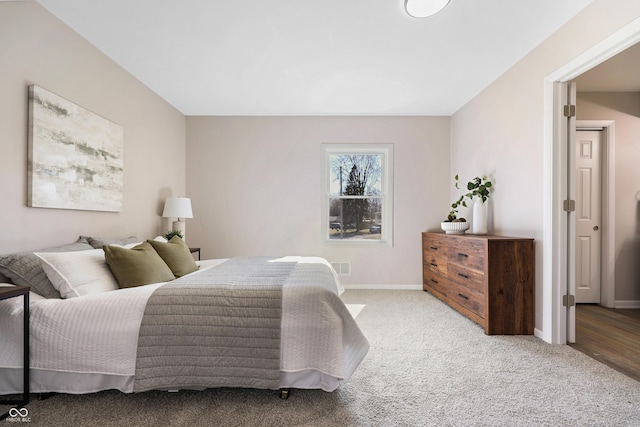 carpeted bedroom featuring visible vents and baseboards