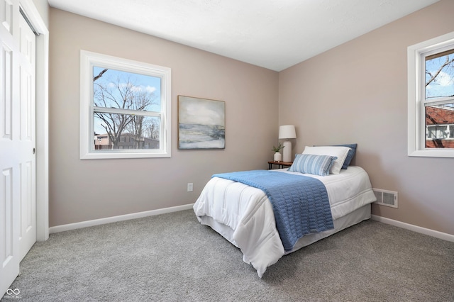 bedroom with baseboards, visible vents, and carpet floors