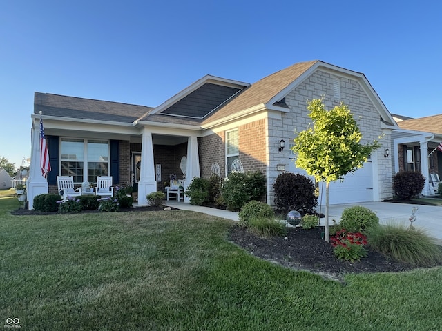 view of front of property featuring driveway, a front lawn, a porch, a garage, and brick siding