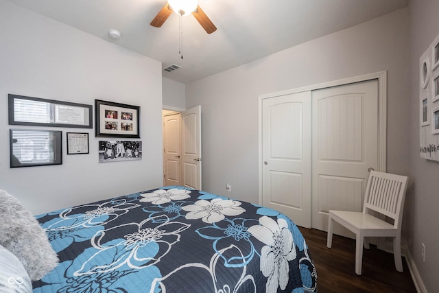 bedroom featuring visible vents, a closet, wood finished floors, and a ceiling fan