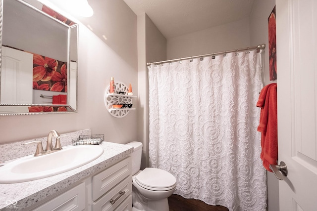 full bathroom with vanity, curtained shower, and toilet