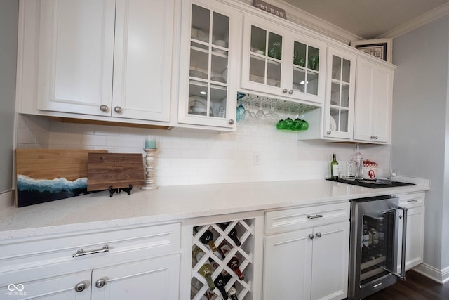 bar featuring wine cooler, a bar, and tasteful backsplash