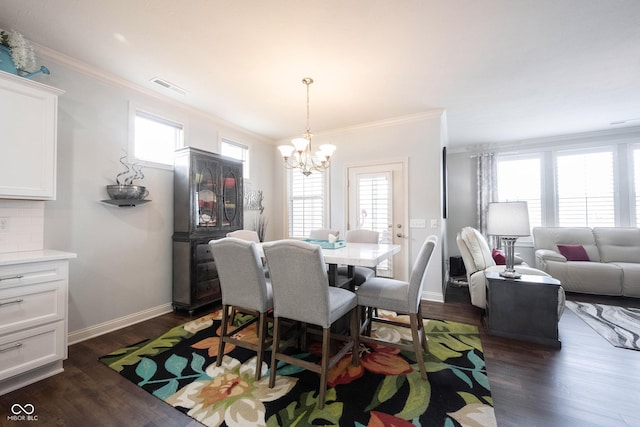 dining room with a chandelier, plenty of natural light, dark wood-type flooring, and ornamental molding