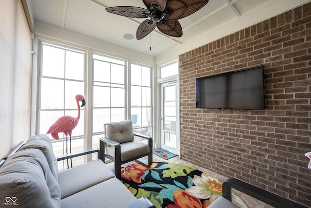 living area with brick wall and ceiling fan