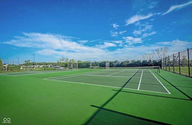 view of tennis court with fence