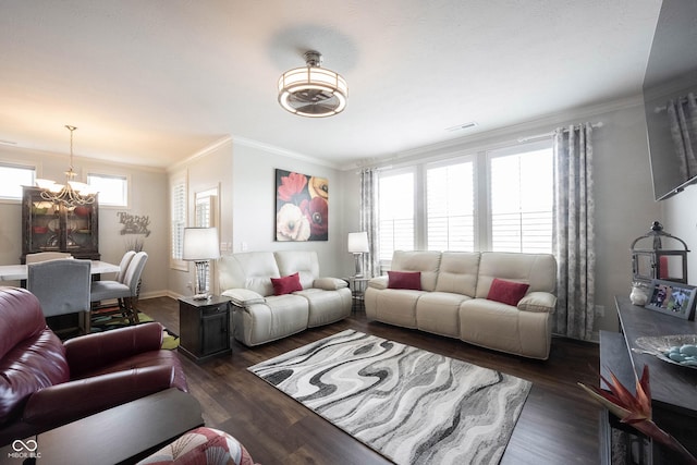 living room featuring visible vents, crown molding, baseboards, wood finished floors, and a notable chandelier