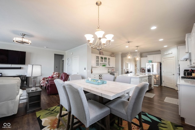 dining room with dark wood-type flooring, recessed lighting, crown molding, and a chandelier