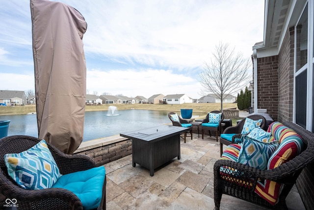 view of patio / terrace with an outdoor living space, a water view, and a residential view