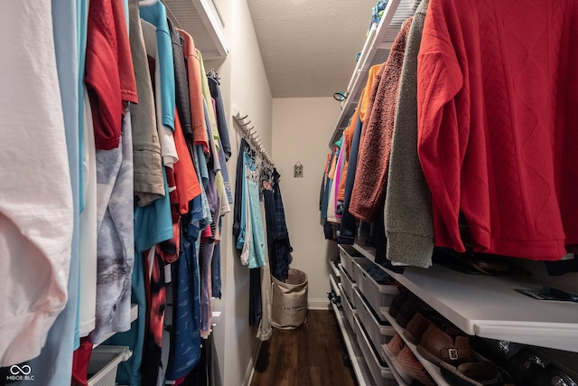 walk in closet featuring dark wood-style floors