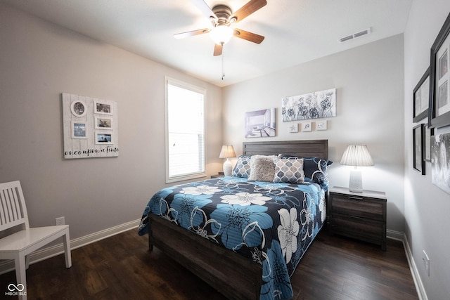 bedroom with a ceiling fan, wood finished floors, visible vents, and baseboards