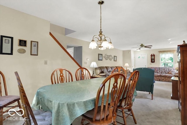 carpeted dining room featuring a ceiling fan