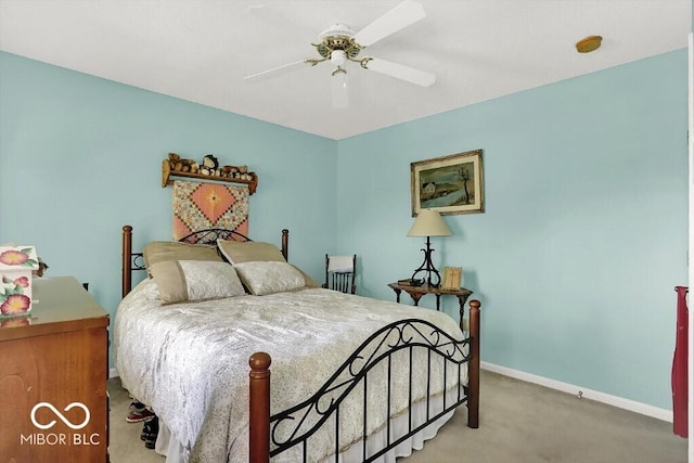 carpeted bedroom featuring baseboards and a ceiling fan