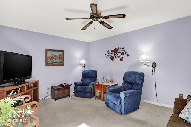 sitting room featuring baseboards, a ceiling fan, and carpet flooring