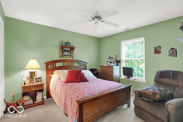 carpeted bedroom featuring visible vents and a ceiling fan