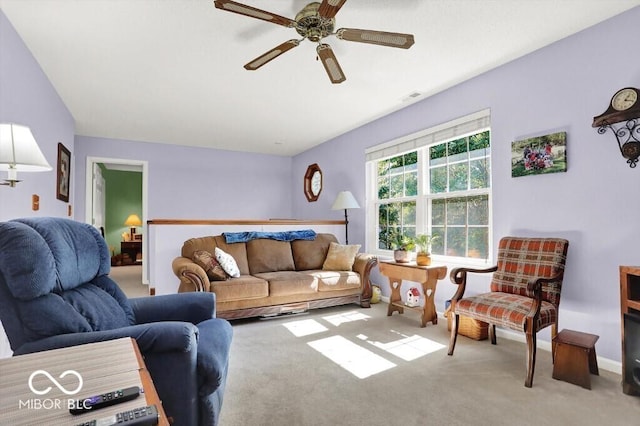 carpeted living area featuring visible vents, baseboards, and a ceiling fan