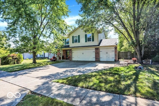 traditional-style house featuring fence, concrete driveway, an attached garage, a front yard, and brick siding