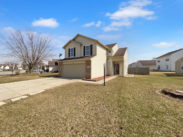 traditional-style house with a front yard, fence, driveway, a garage, and brick siding