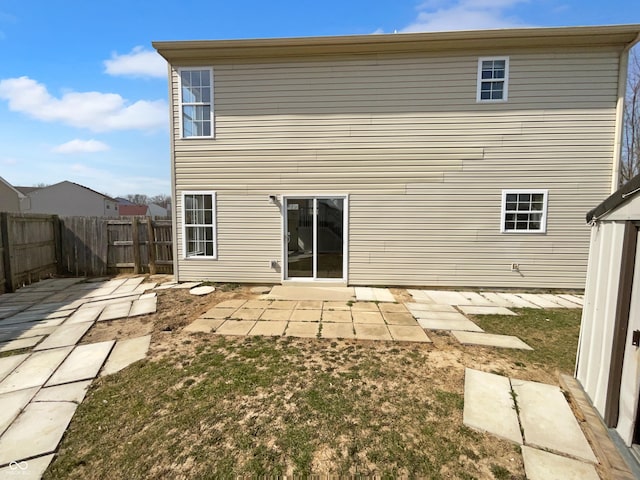 back of house featuring fence and a patio area