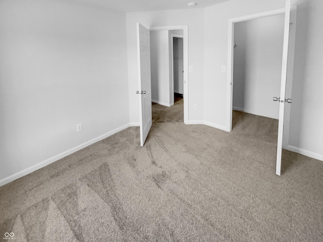 unfurnished bedroom with baseboards and carpet flooring