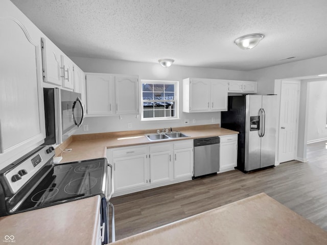 kitchen featuring white cabinetry, appliances with stainless steel finishes, and a sink