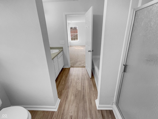 full bath with vanity, toilet, baseboards, and a shower with shower door