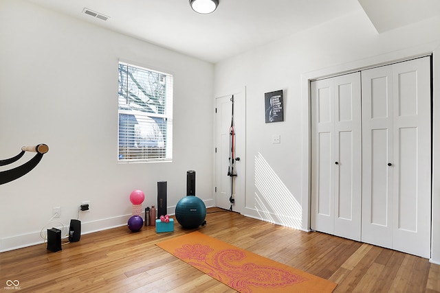 1209 N Rural St, Indianapolis, IN 46201 - exercise room with visible vents, baseboards, and hardwood / wood-style floors