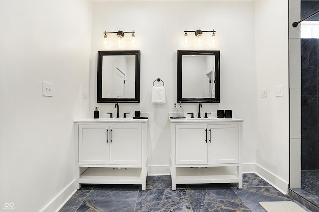 1209 N Rural St, Indianapolis, IN 46201 - bathroom with two vanities, baseboards, a tile shower, and a sink