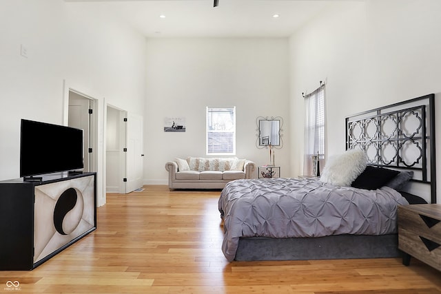 1209 N Rural St, Indianapolis, IN 46201 - bedroom featuring a high ceiling, recessed lighting, baseboards, and light wood finished floors