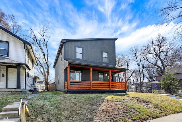 view of front of house featuring covered porch and a front yard