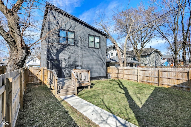 1209 N Rural St, Indianapolis, IN 46201 - rear view of property featuring a deck, a lawn, and a fenced backyard