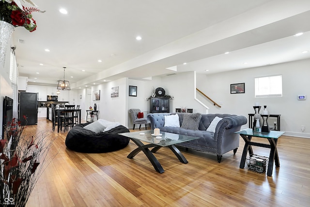 1209 N Rural St, Indianapolis, IN 46201 - living area with visible vents, light wood-style flooring, recessed lighting, baseboards, and stairs