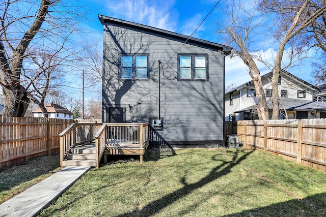 1209 N Rural St, Indianapolis, IN 46201 - rear view of property featuring a fenced backyard, a yard, and a deck