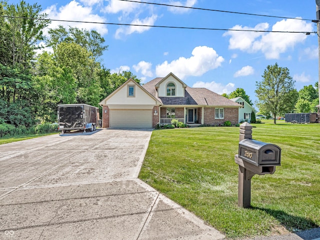 view of front of home with brick siding, an attached garage, concrete driveway, and a front yard