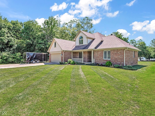 view of front of house with brick siding, driveway, an attached garage, and a front lawn