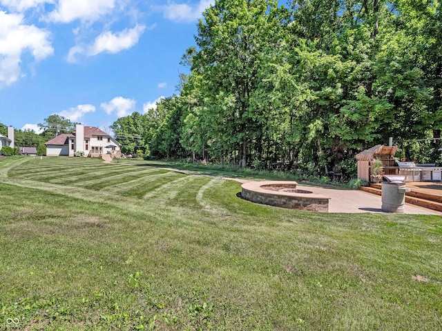 view of yard with a patio and a fire pit