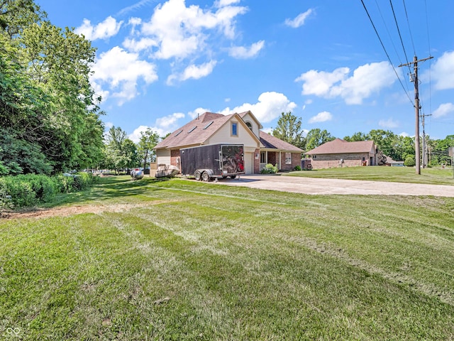 view of yard featuring concrete driveway and a garage